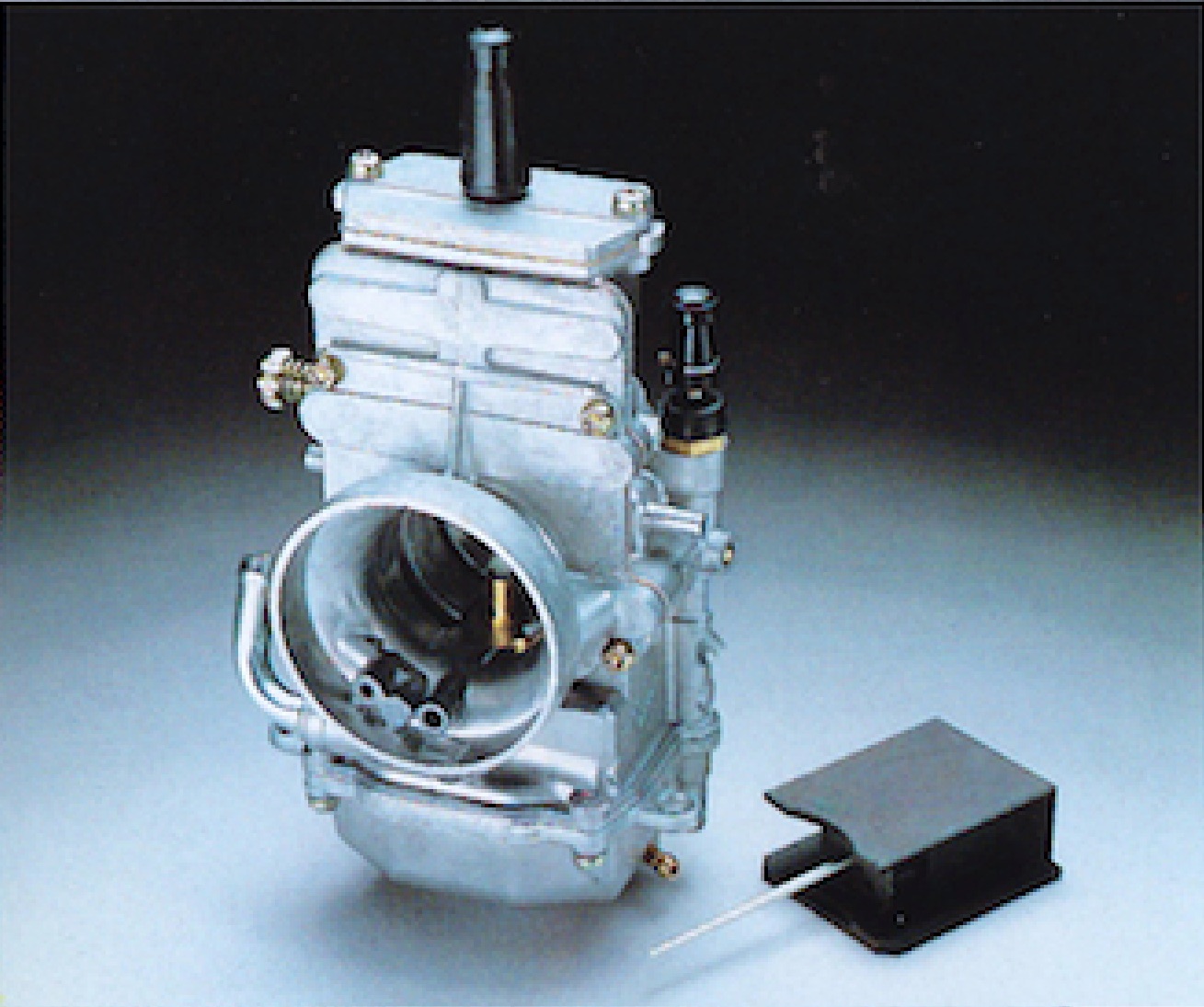 The RM's 34mm flat-slide Mikuni carburetor looked cool, but did very little to aid the Suzuki's meager output.